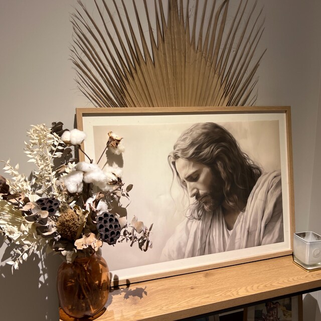 Jesus portrait print on wooden shelf with dried flowers